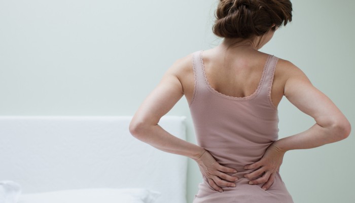 Woman rubbing aching back