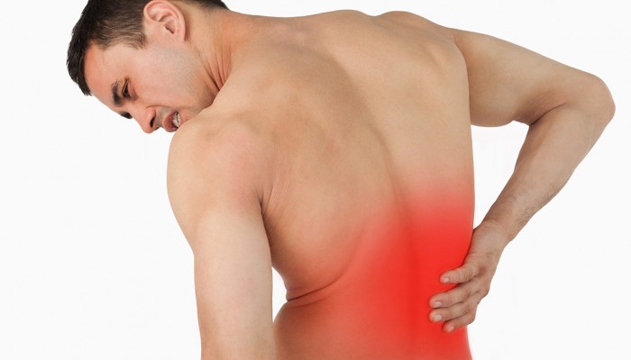 Back view of male suffering from back pain against a white background