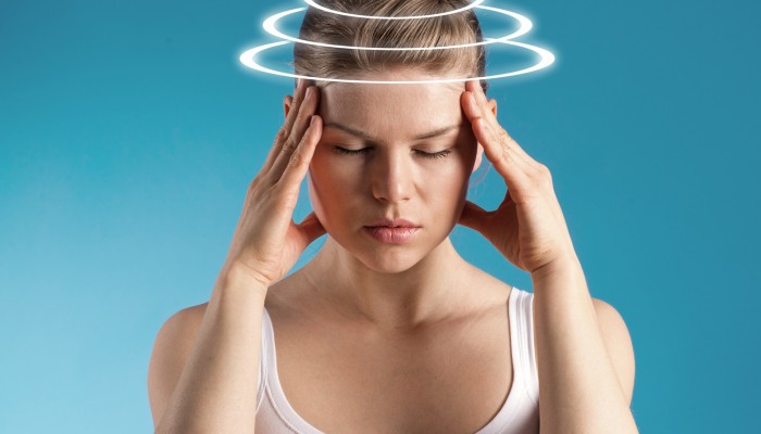 Woman with vertigo. Young patient suffering from dizziness
