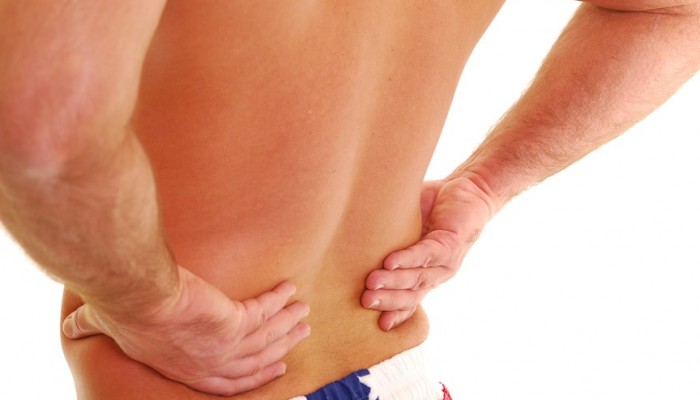 Man with lower back pain isolated on white