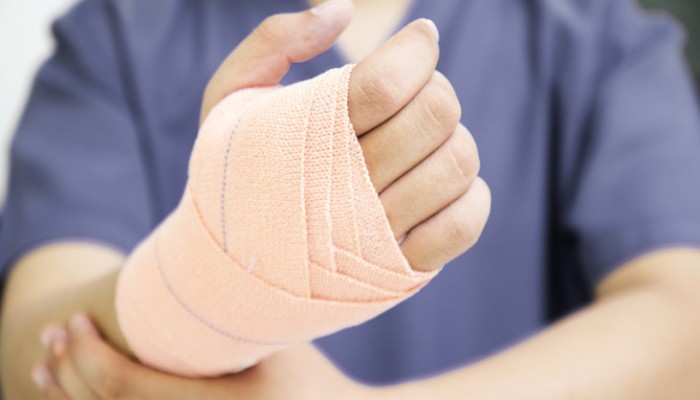 Close up of a hand with medical bandage.