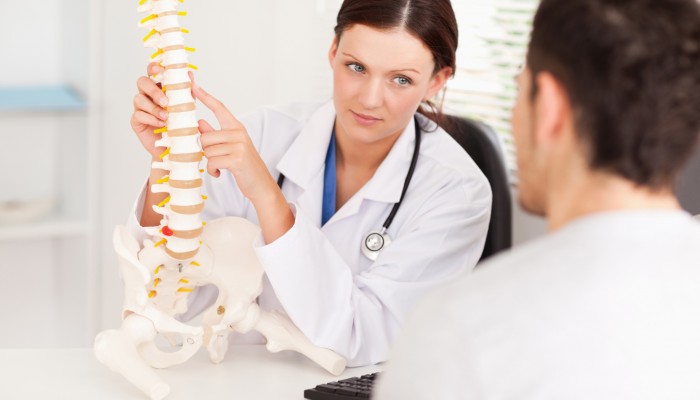 Female doctor showing doctor spine