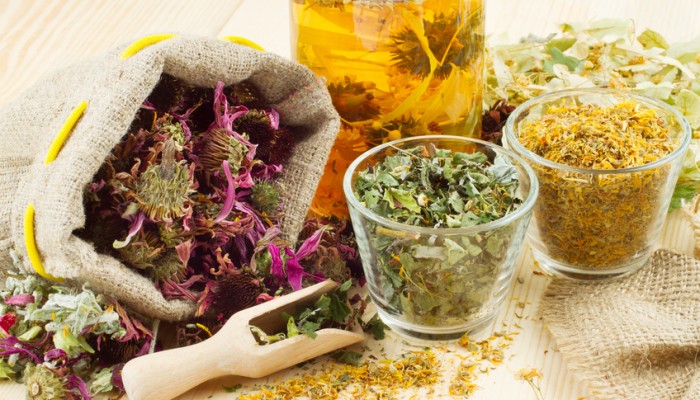 healing herbs and healthy tea on wooden table, herbal medicine