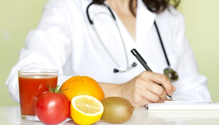 Doctor nutritionist in office with healthy fruits diet concept