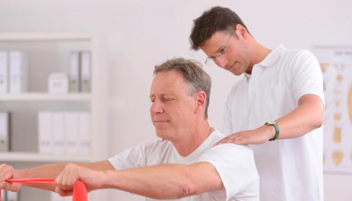 Physiotherapy: Senior man and physiotherapist