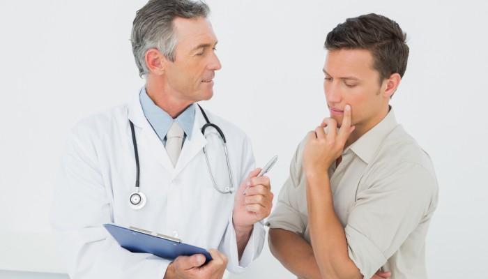 Male doctor in conversation with patient in the medical office