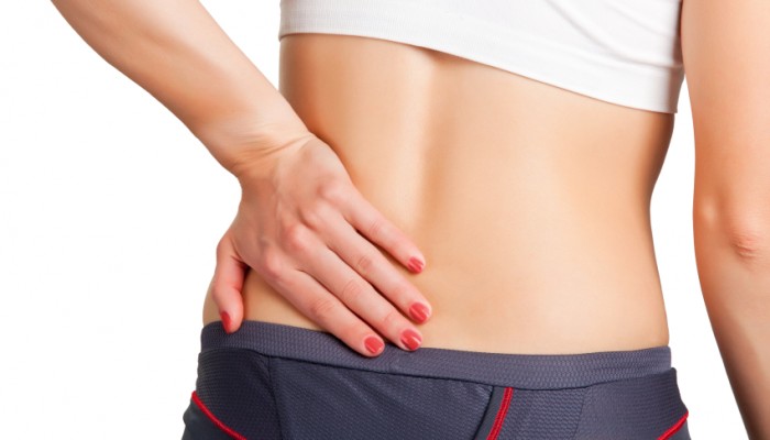 Young woman with pain in her lower back