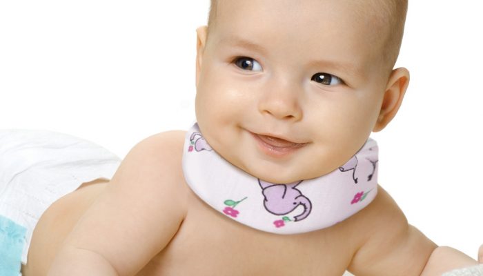 the very beautiful little baby , lie on stomach and crawl, on white background, isolated