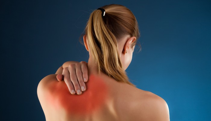 Woman massaging pain back