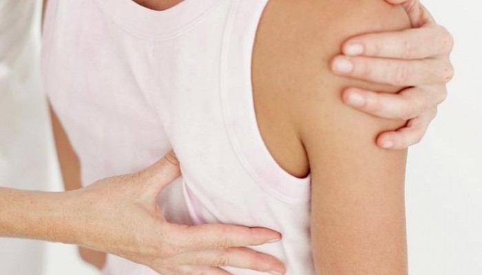 rear view of a young woman getting a back massage