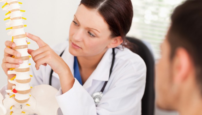 Female doctor showing patient a bone
